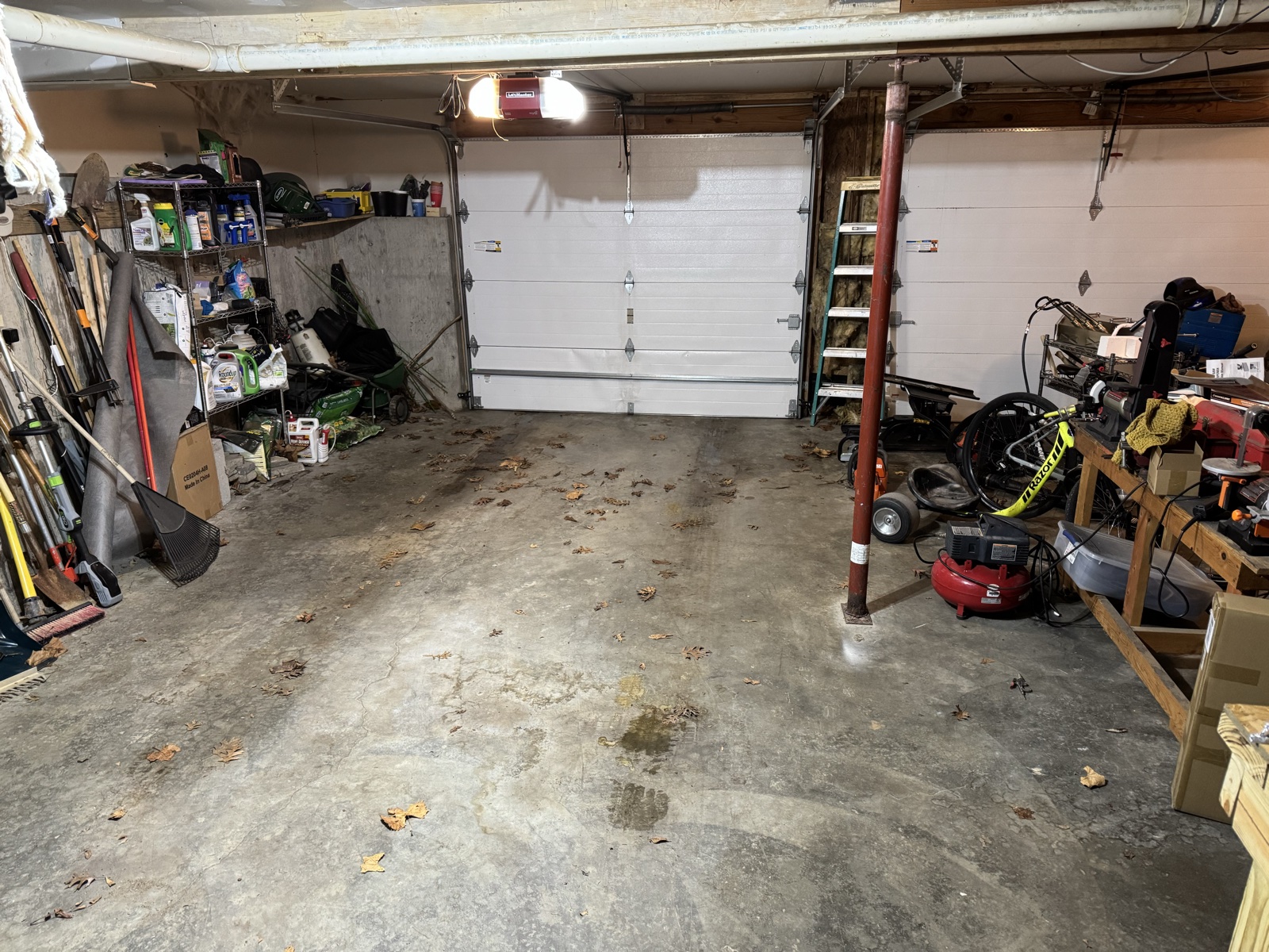 The old two-bay garage with projects and storage spread through the available space