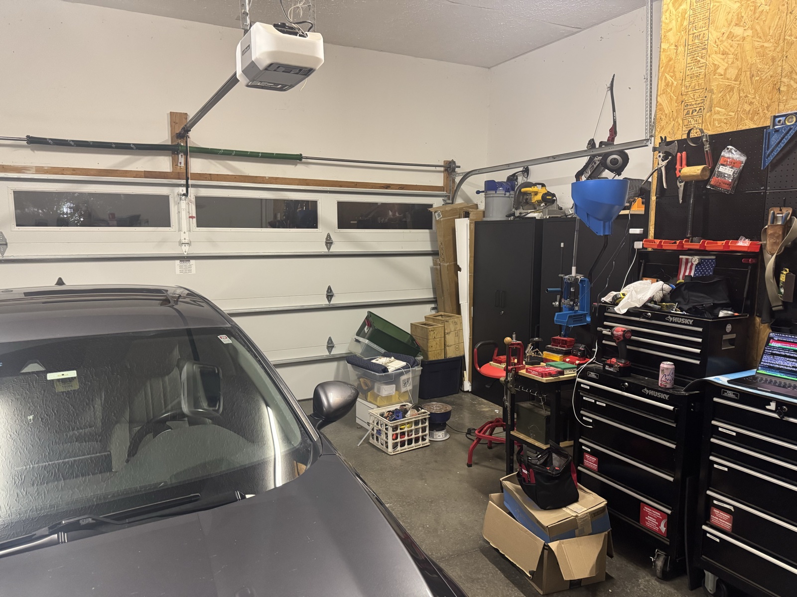 Norma's car parked inside the new garage beside the compact reloading corner