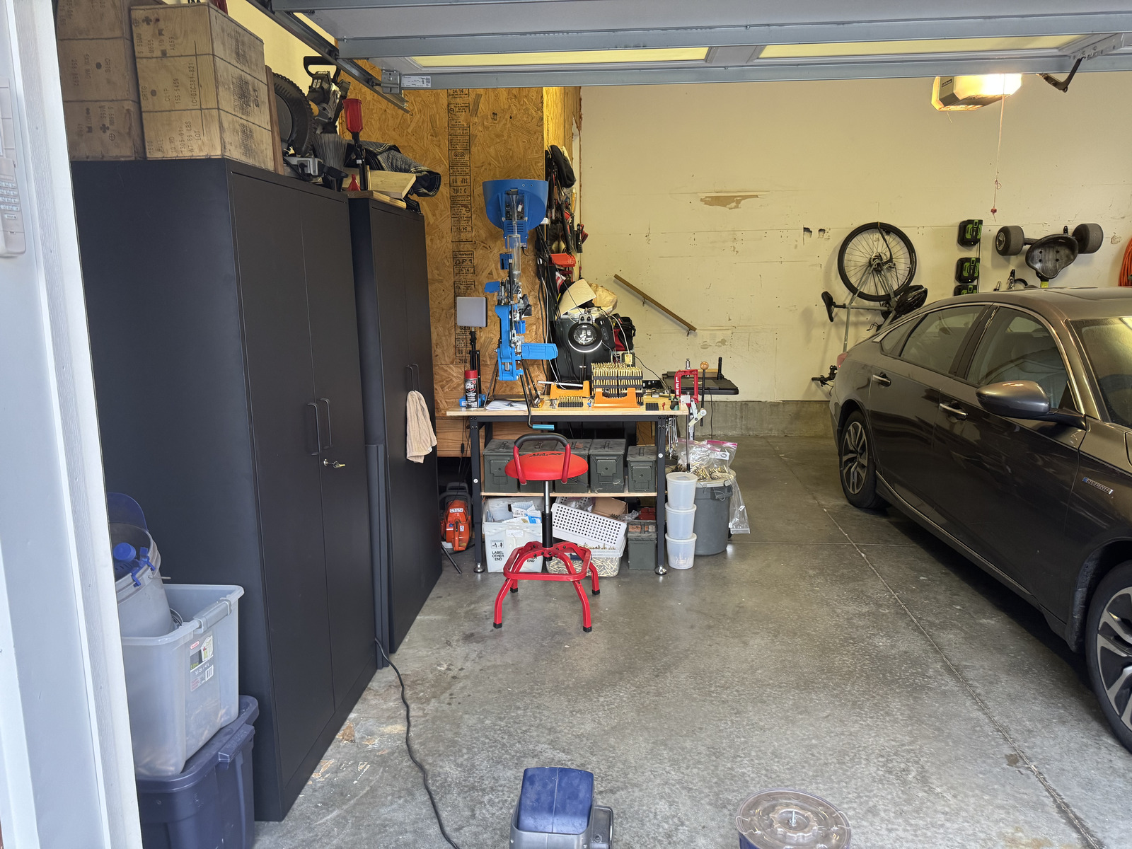 The installed reloading station operating along the left wall while the car remains parked inside the garage