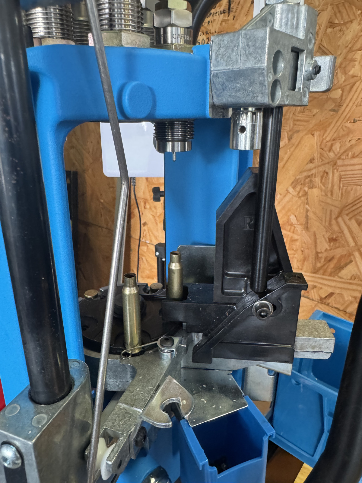 Two empty 5.56 cases occupying positions on the Dillon shellplate beneath the sizing and decapping station