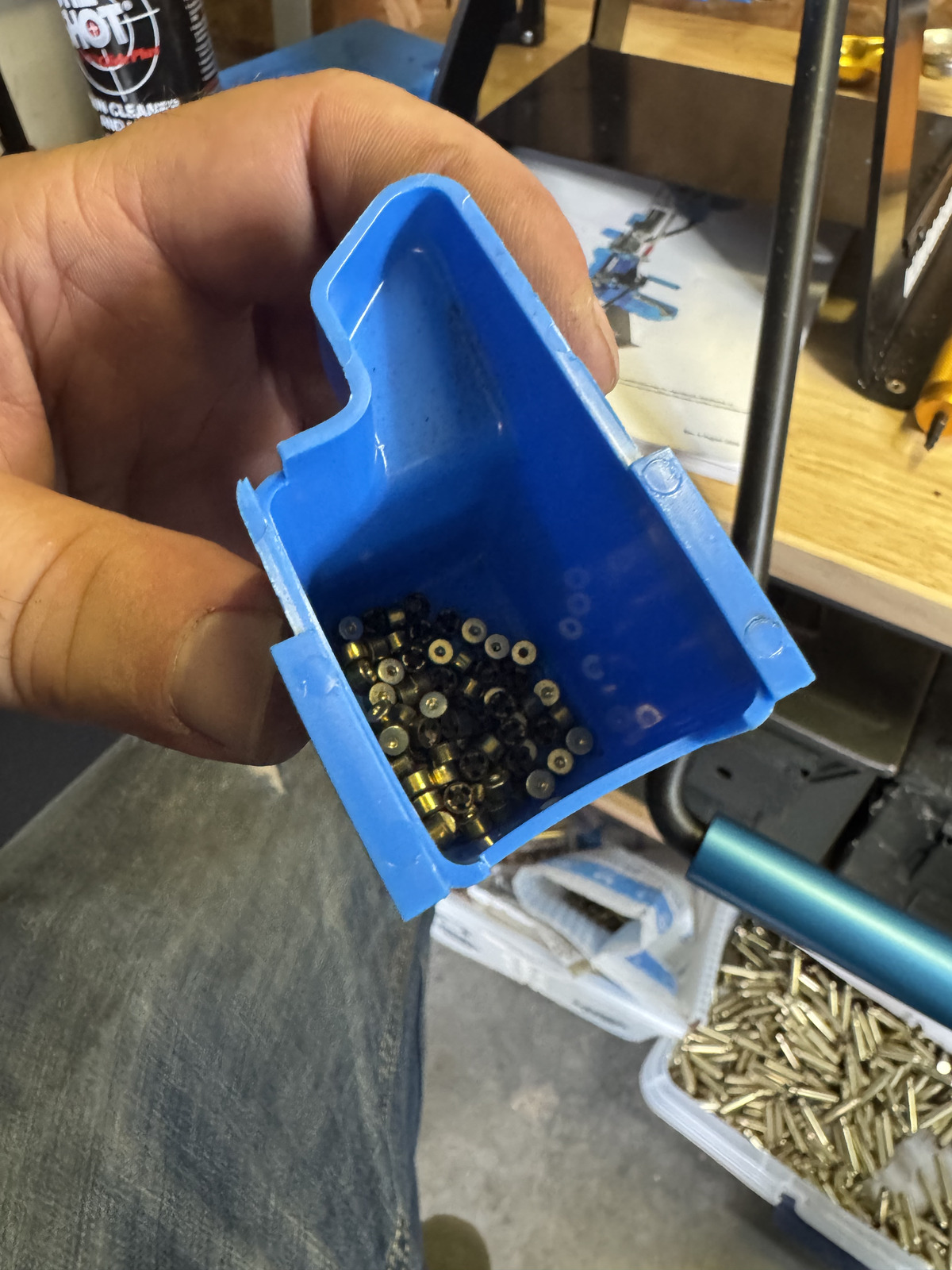 Spent primers collected separately below the Dillon press after the decapping and sizing pass